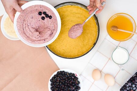 the stages of preparation of a pie with black currants and shortbread crust , fresh berries. the view from the topの写真素材