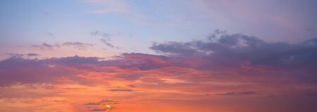 panorama of a blue-pink sunset with clouds of pink hues. sunset on the horizon. photo for the banner. space for textの写真素材