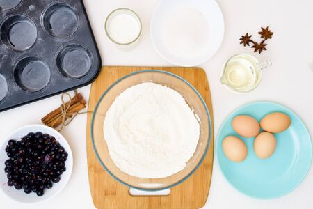 step by step recipe for muffins with black currants . preparing the dough, mixing the ingredients of flour, butter, sugar, eggs, vanilla, currant. the view from the topの写真素材