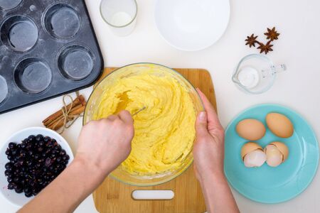 step by step recipe for muffins with black currants . preparing the dough, mixing the ingredients of flour, butter, sugar, eggs, vanilla, currant. the view from the topの写真素材