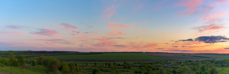 panorama of a blue-pink sunset with clouds of pink hues. sunset on the horizon. photo for the...