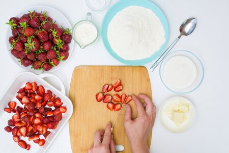 step by step recipe strawberry cobbler homemade from ripe fresh strawberries and shortbread on a light background, top view. ingredients for strawberry pie.の写真素材