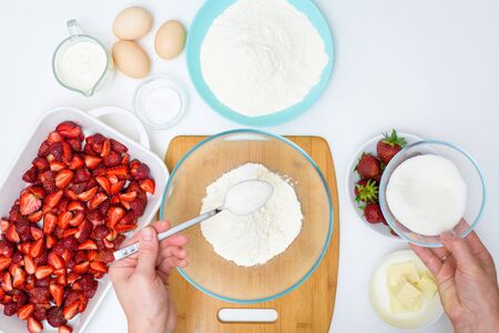 step by step recipe strawberry cobbler homemade from ripe fresh strawberries and shortbread on a light background, top view. ingredients for strawberry pie.の写真素材