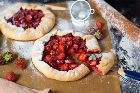 homemade strawberry Galette with fresh ripe strawberries on a dark background.の写真素材