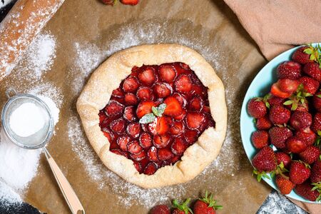 homemade strawberry Galette with fresh ripe strawberries on a dark background.の写真素材