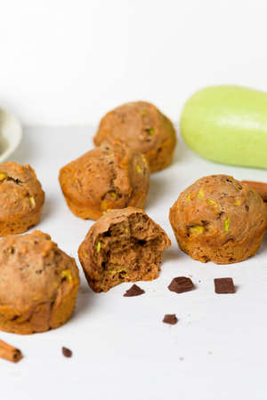 chocolate muffins with zucchini and banana. wet veggie cupcakes home-made, top view on a light background. cooking muffins in the kitchen. in the split view.の写真素材