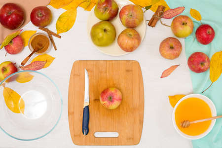 Autumn baking concept. step-by-step recipe for baking a traditional autumn Apple pie, copy the space on a light background. cut apples and mix with cinnamon and sugar.の写真素材