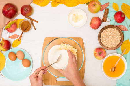 Apple crisp crumble, step-by-step recipe and mixing ingredients for home cooking on a light background top view. traditional autumn dessert with cinnamon and oatmeal, honey.の写真素材