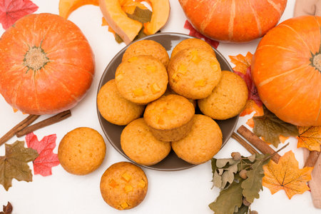 recipe and ingredients for cooking autumn pumpkin cupcakes. top view on a light background. fresh...