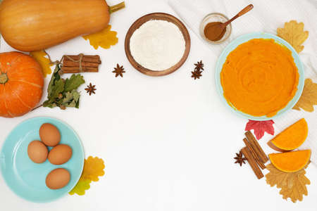 step-by-step recipe for cooking homemade pumpkin pie with spices ingredients on plates top view on a light backgroundの写真素材