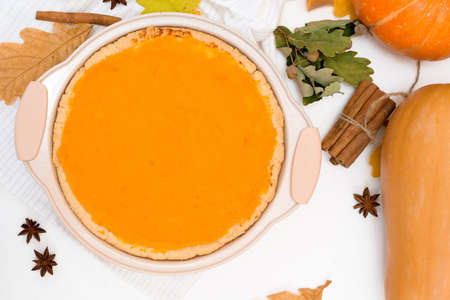 cooking homemade pumpkin pie with spices top view on a light background. autumn dessert of seasonal orange pumpkins.の写真素材