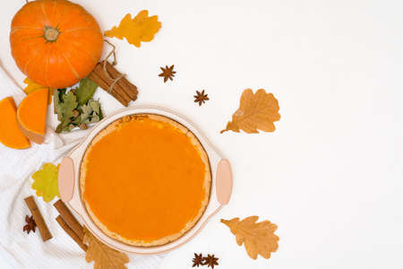cooking homemade pumpkin pie with spices top view on a light background. autumn dessert of seasonal orange pumpkins.の写真素材