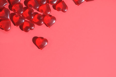 valentine's day mockup greeting card with red hearts on red background, for text place. festive wedding background, bluer focus.の写真素材