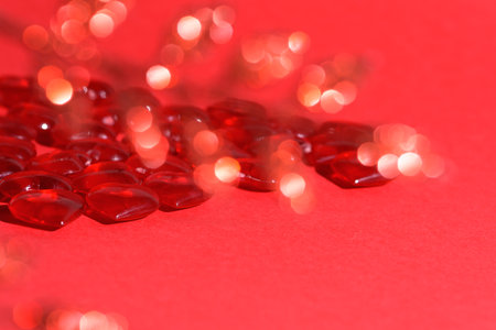 valentine's day mockup greeting card with red hearts on red background, for text place. festive wedding background, bluer focus.の写真素材