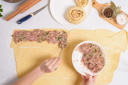 the process of cooking Uzbek manti at home, the ingredients are meat, vegetables, dough. woman's hands sculpt manti.の写真素材