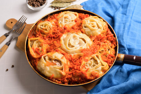uzbek manti at home in a frying pan with stewed vegetables, ingredients-meat, vegetables, dough. top view on a light background.の写真素材