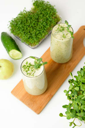 smoothie of micro-green apples cucumber and spinach on a light background. eco organic fresh food detox . ingredients fresh micro-greens . close-up selective focusの写真素材