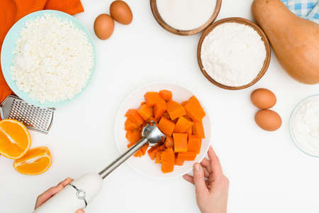 step-by-step recipe for pumpkin curd casserole in the shape of a zebra, orange autumn pie with orange. mixing ingredients for pumpkin pie top view.の写真素材