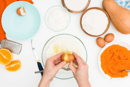 step-by-step recipe for pumpkin curd casserole in the shape of a zebra, orange autumn pie with orange. mixing ingredients for pumpkin pie top view.の写真素材