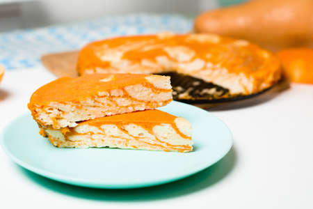 pumpkin casseroles with zebra-shaped cottage cheese, autumn orange pie. cut the pie into pieces on a plate .の写真素材