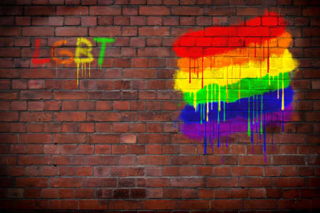 LGBT lettering and rainbow graffiti, on a brick wall.の写真素材