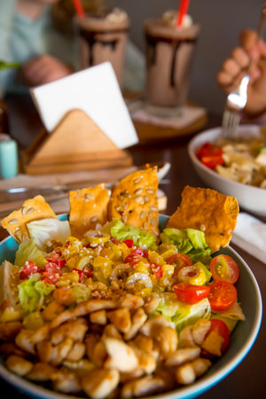 Freshly prepared salad, garnished with olives, tomatoes and crackers with chicken.の写真素材