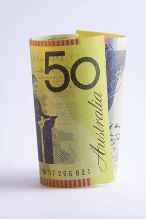 rolled up Australian 50 dollar note on white backgroundの写真素材