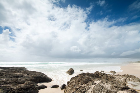 clouds over beautiful beach during the day (currumbin beach,gold coast,queensland,australia)の写真素材