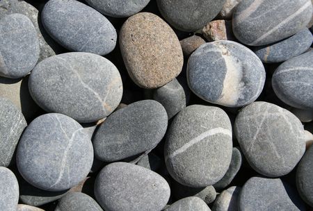Grey pebbles on the beach can use as background の写真素材