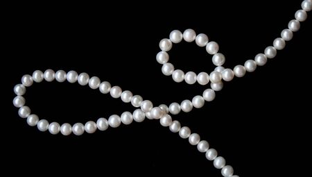 White pearls on the black velvet background の写真素材