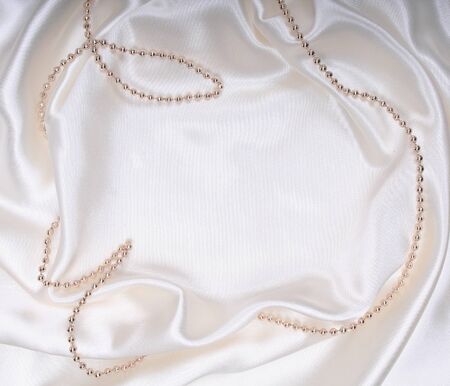 New Year's tinsel on white silkの写真素材