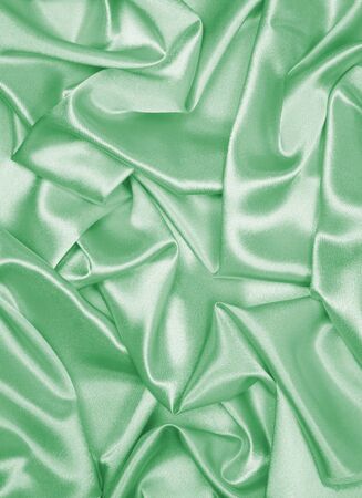 Smooth elegant green silk or satin can use as backgroundの写真素材