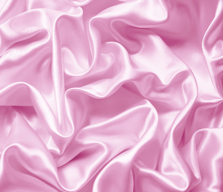 Smooth elegant pink silk or satin texture can use as backgroundの写真素材