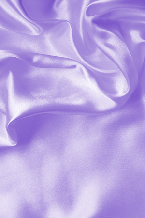 Smooth elegant lilac silk or satin texture can use as backgroundの写真素材
