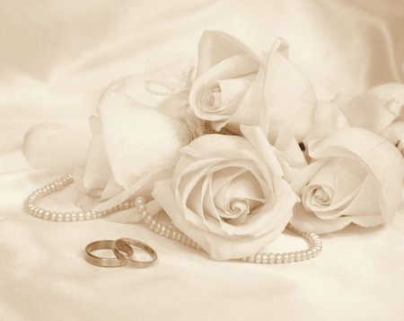 Wedding rings and roses as wedding background. In Sepia toned. Retro styleの写真素材
