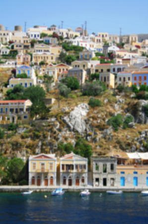 Greece. Island Symi (Simi). Colorful houses in the Mandraki harbor. In blur styleの写真素材