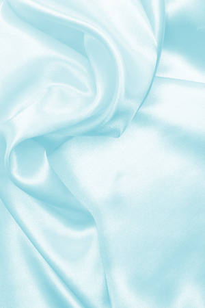 Smooth elegant blue silk or satin texture can use as backgroundの写真素材