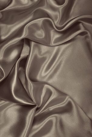 Smooth elegant brown silk or satin texture can use as abstract background. Luxurious background design wallpaper. In Sepia toned. Retro styleの写真素材