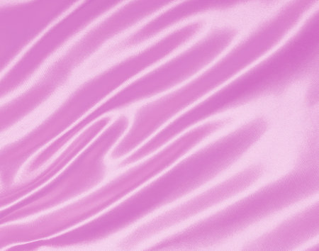 Smooth elegant pink silk or satin texture can use as backgroundの写真素材