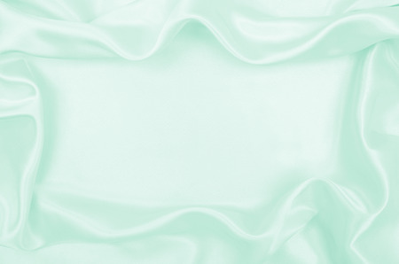 Smooth elegant green silk or satin luxury cloth texture can use as abstract background. Luxurious background designの写真素材