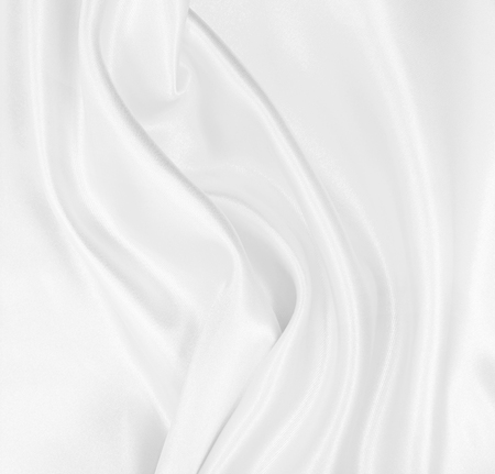 Smooth elegant white silk or satin luxury cloth texture can use as wedding background. Luxurious background designの写真素材