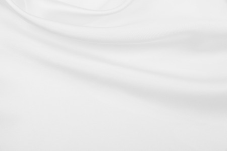 Smooth elegant white silk or satin luxury cloth texture can use as wedding background. Luxurious background designの写真素材