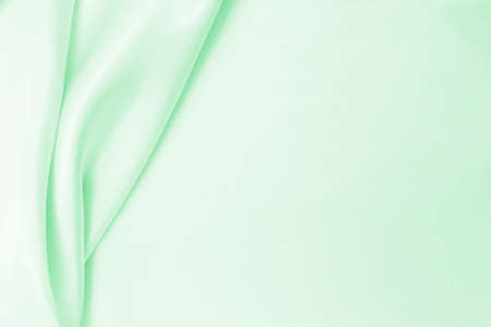 Smooth elegant green silk or satin luxury cloth texture can use as abstract background. Luxurious background designの写真素材