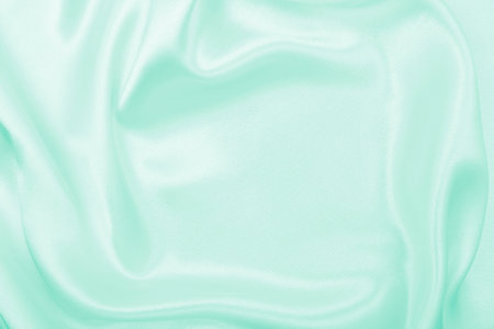 Smooth elegant green silk or satin luxury cloth texture can use as abstract background. Luxurious...