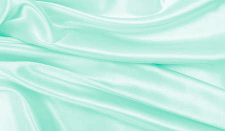 Smooth elegant green silk or satin luxury cloth texture can use as abstract background. Luxurious background designの写真素材