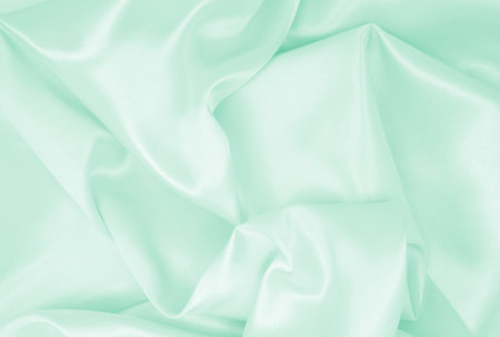 Smooth elegant green silk or satin luxury cloth texture can use as abstract background. Luxurious...