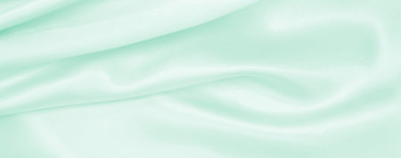 Smooth elegant green silk or satin luxury cloth texture can use as abstract background. Luxurious background designの写真素材