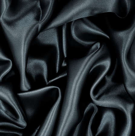 Smooth elegant black silk or satin texture can use as abstract background. Luxurious background designの写真素材
