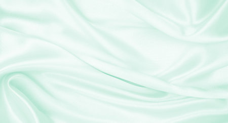 Smooth elegant green silk or satin luxury cloth texture can use as abstract background. Luxurious background designの写真素材