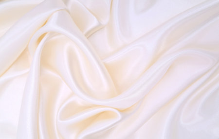 Smooth elegant white silk or satin luxury cloth texture can use as wedding background. Luxurious background designの写真素材